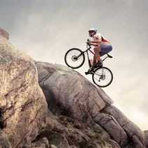  Mountain biker riding up a rocky hill
