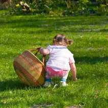 A little girl picking grass