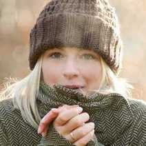  Woman wearing cardigan and cap being cold