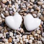  Two ceramic hearts laid on stones