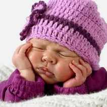 Sleeping baby with a pink cap