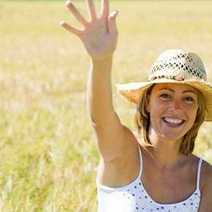a women in a hat waving