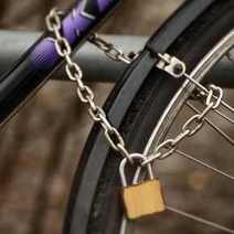 Detail on a bicycle secured by a chain and lock